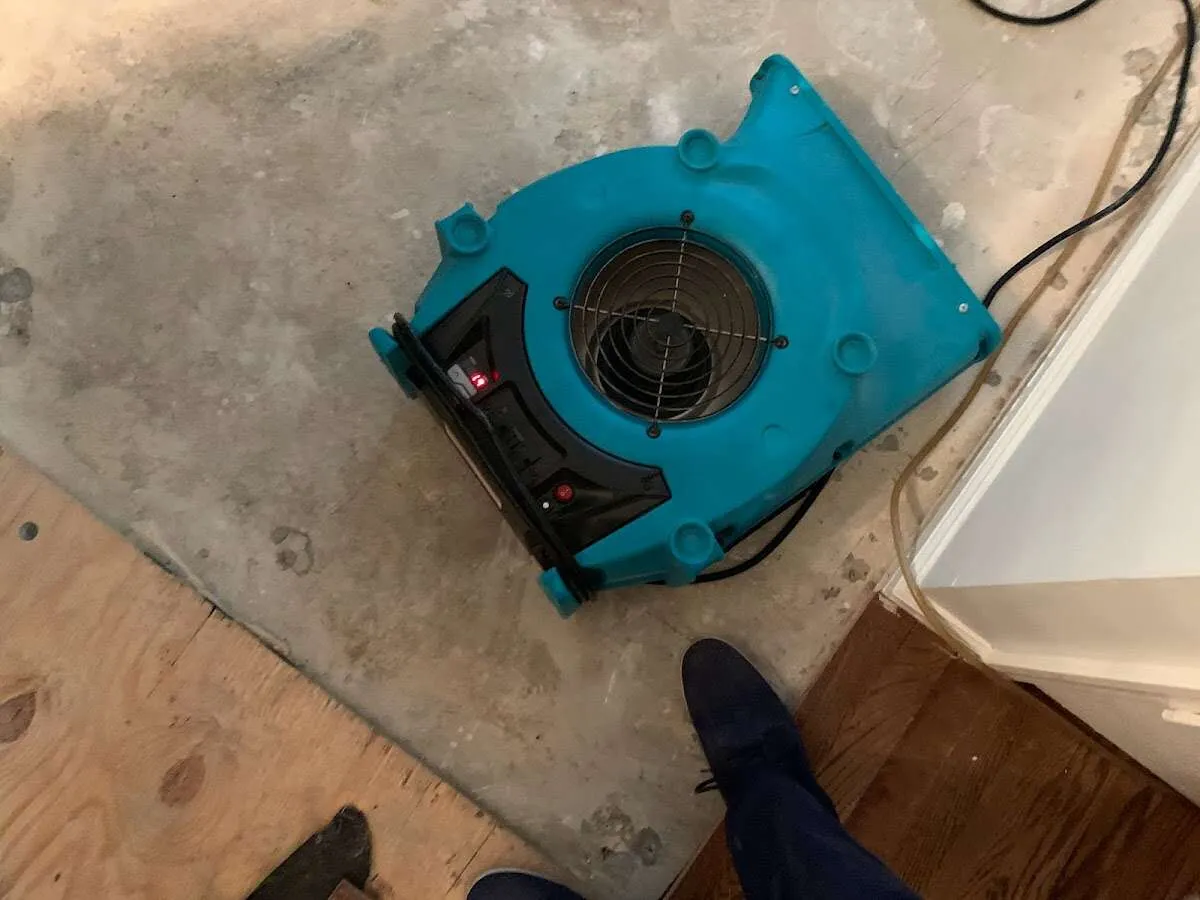 Air mover drying subfloor during Leak Detection & Repair in Youngstown
